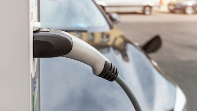 The Plug of a EV charger placed into its charging socket on a car