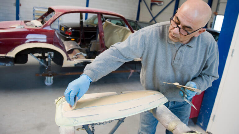 A machanic working on a car