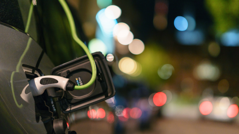 The Plug of a EV charger placed into its charging socket on a car