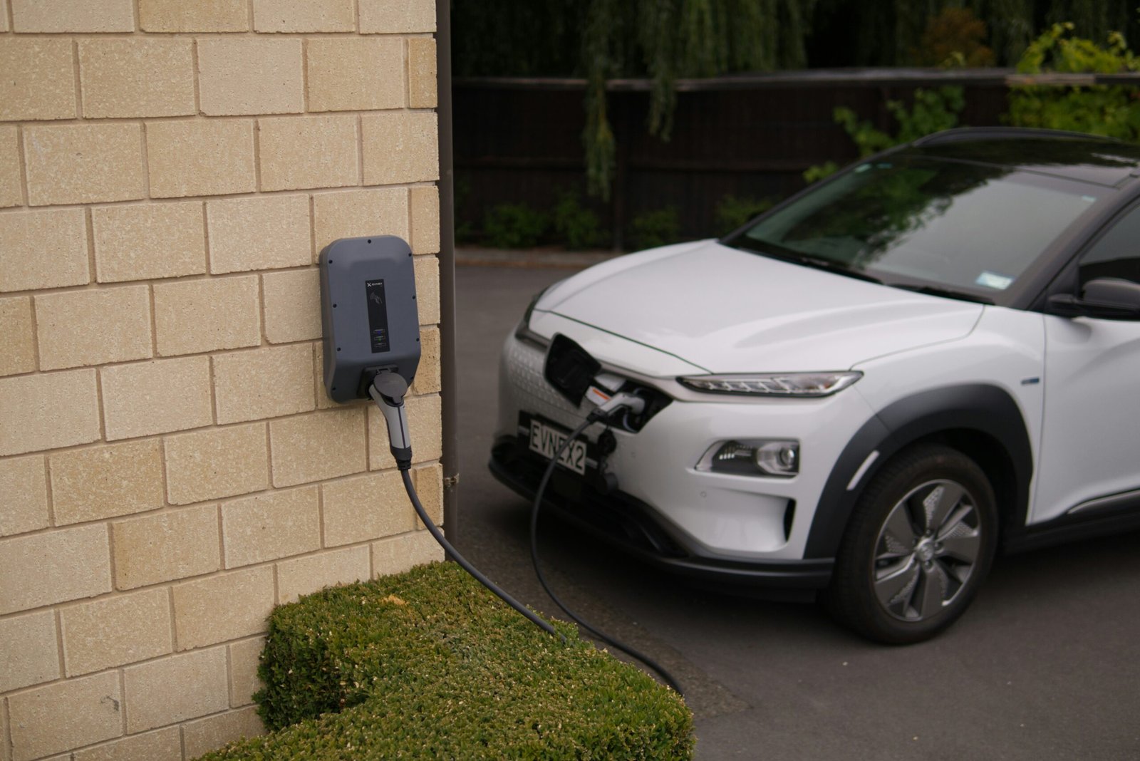 a electric car plugged in to a wall charger