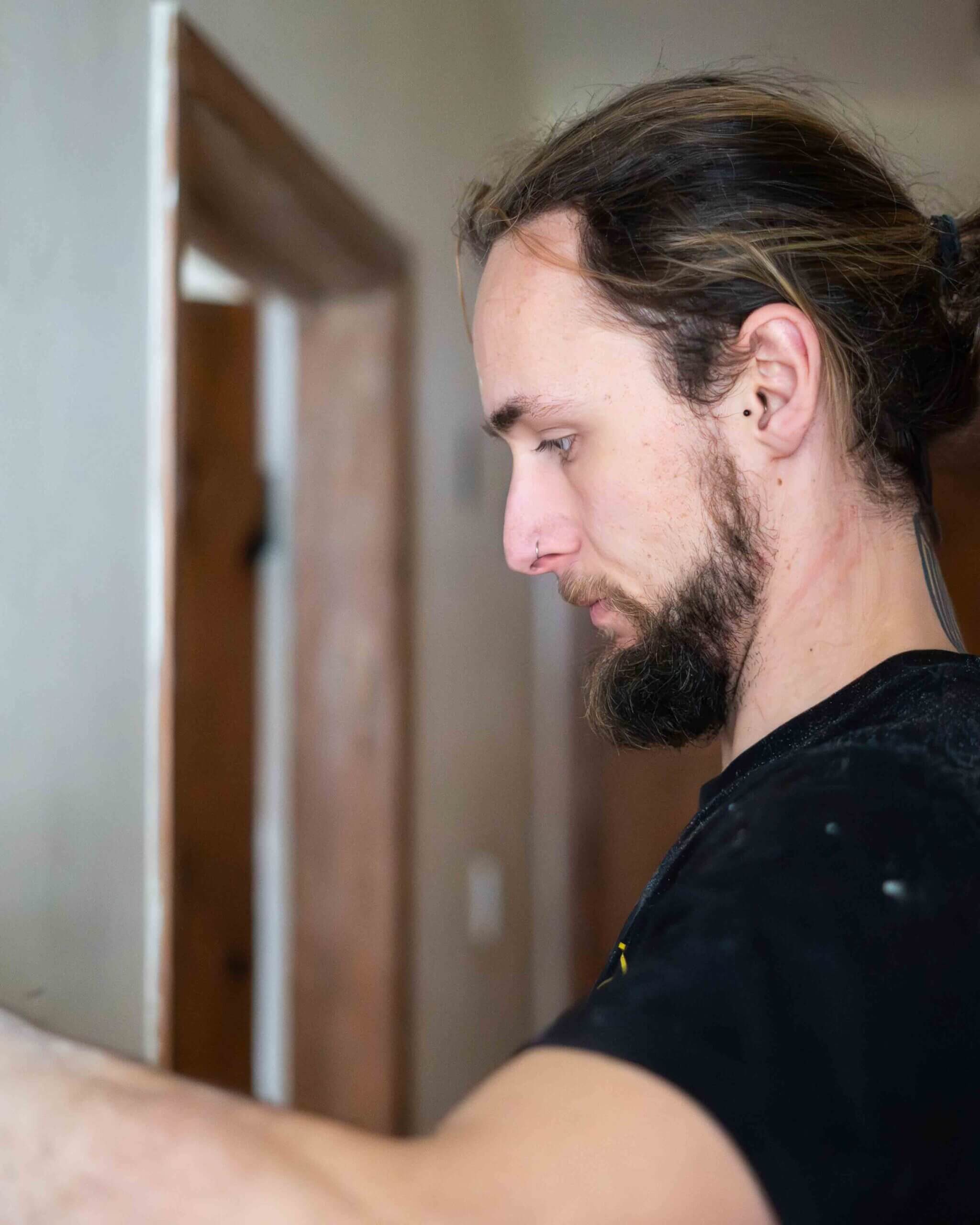 A F Denning Electrician working on a light fitting